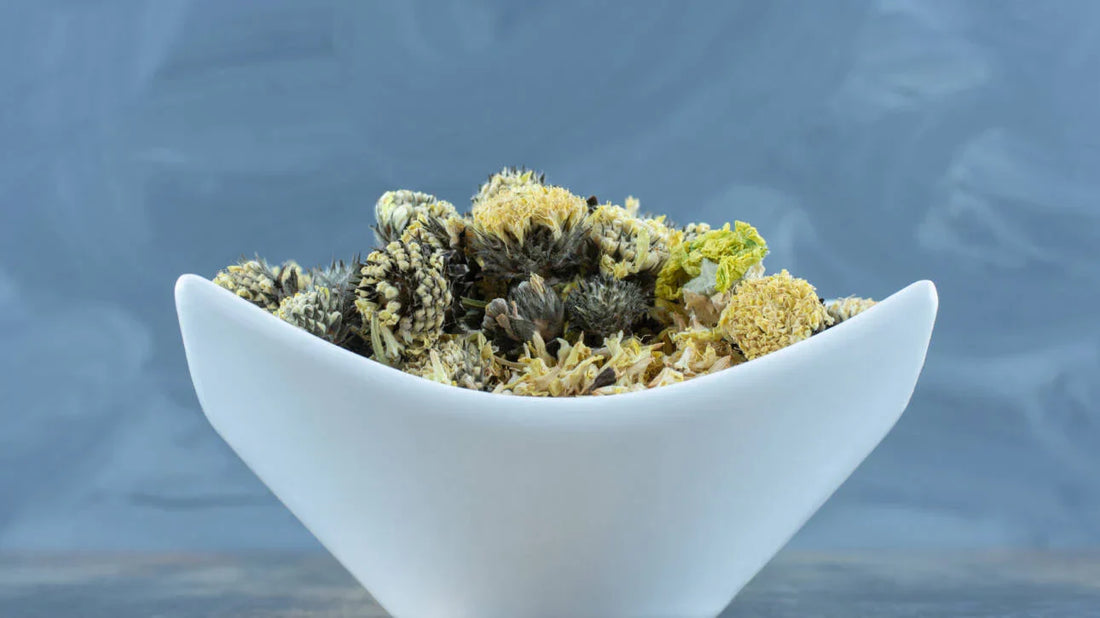 Dried botanical flower on white plate for THCa cannabinoid guide - Pure Shaka
