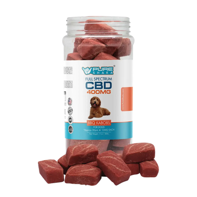 A clear glass jar filled with reddish-brown, rectangular cbd treats labeled ’pure shaka full spectrum cbd 400mg bbq kabobs for dogs.’